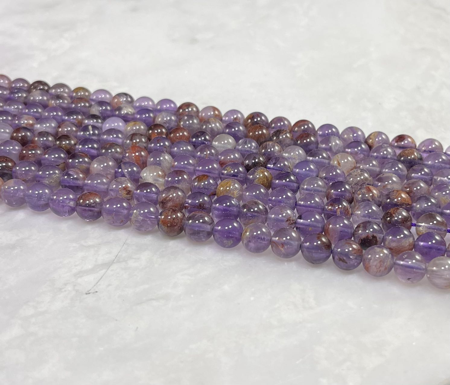 Auralite 23 aka Amethyst w/ Hematite Inclusions Round